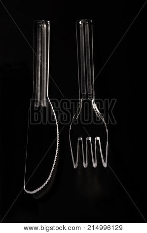 fork and knife of methacrylate on black background