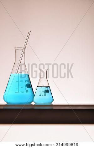 Assortment Of Glass Containers For Laboratory Warm Background Vertical
