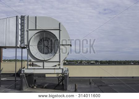 Commericial Ventilation Fan On A Rooftop Of A High Rise Building Side View