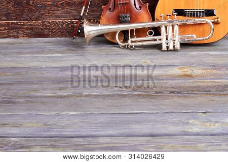 Classical Musical Instruments And Copy Space. Rusty Trumpet, Classical Violin And Acoustic Guitar On