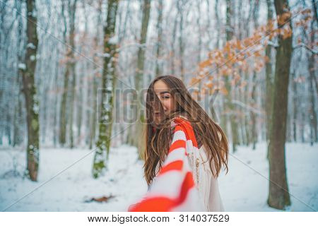 Girl Playing With Snow In Park. Women In Winter Clothes. Portrait Of A Beautiful Woman Dressed A Coa
