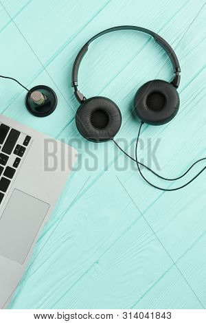 Headphones And Laptop, Top View. Laptop, Mini Stereo Condenser Microphone And Headset On Blue Wooden