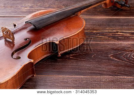 Old-fashioned Violin On Wooden Background. Aged Cello And Copy Space. Baroque Style Instrument.