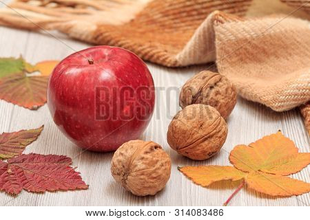 Apple, Walnuts And Dry Leaves In An Autumn Still Llife.