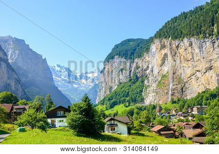 Amazing View Of Picturesque Lauterbrunnen Village With Famous Staubbach Falls In Background. Popular