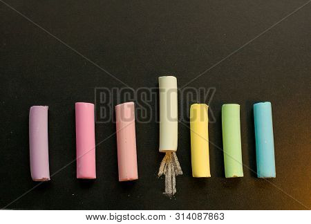 Crayons Of Different Colors Lie On The Slate Ieave A Trace