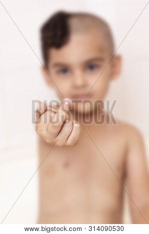 Six-year-old Boy With Half-cut Hair Showing Middle Finger. 6-year Kid Hand Gesturing With His Middle