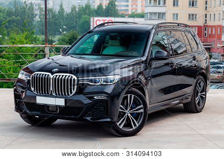 Novosibirsk, Russia - 07.20.2019: Black New Bmw X7 Xdrive40i 2019 Year Front View With Light Gray In