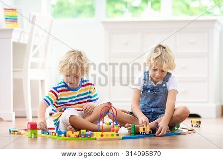 Kids Play Wooden Railway. Child With Toy Train.