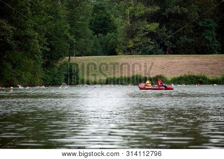 Degenbachsee, Germany, 28. July 2019. Water Rescuer On A Motorboat Watching Swimming People During I