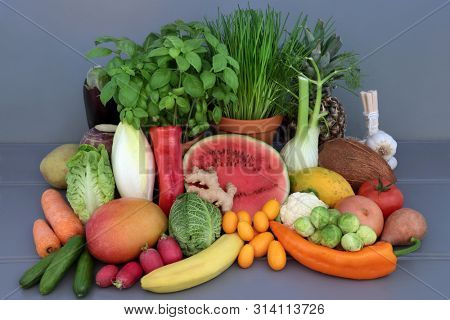 Alkaline health food for ph balance concept with fresh fruit, vegetables and herbs. High in antioxidants, anthocyanins, fibre, minerals and vitamins.