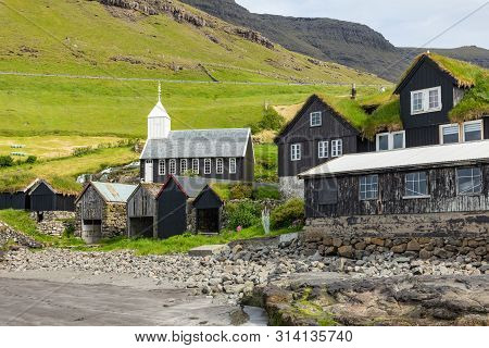 Bour Village. Typical Grass-roof Houses And Green Mountains. Vagar Island, Faroe Islands. Denmark. E