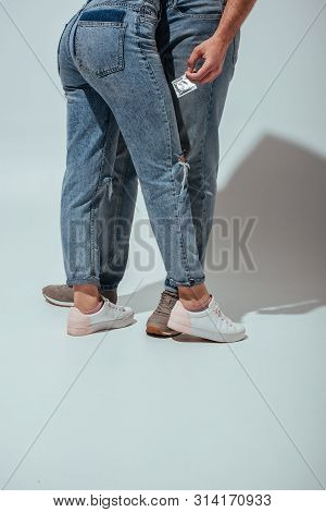 Cropped View Of Couple Standing Close To Each Other While Man Holding Condom In Hand