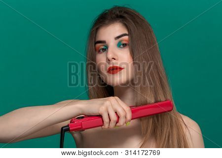 Portrait Of Beautiful Young Woman With Bright Color Make-up Doing Hair Style Herself With A Purple S