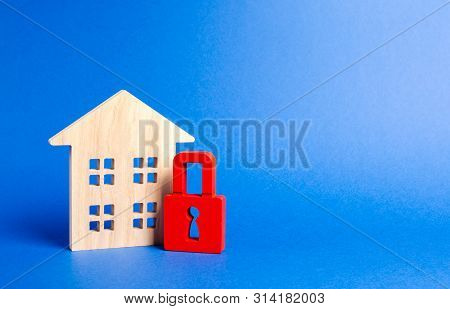Wooden House And A Red Padlock. Security And Safety. Unavailable And Expensive Real Estate. House In