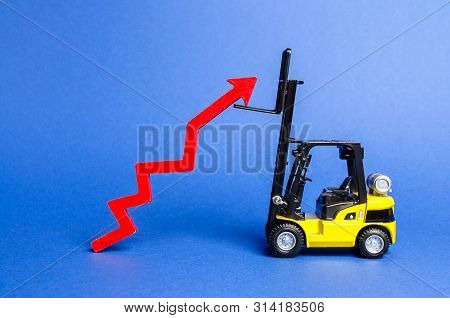 A Yellow Forklift Raises A Big Red Arrow Up. Growth In Production Rates And Development Of Industry 