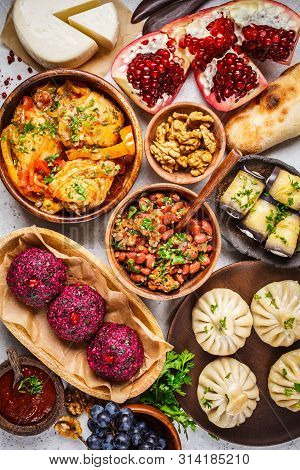 Traditional Georgian Cuisine Background. Khinkali, Phali, Chahokhbili, Lobio, Cheese, Eggplant Rolls