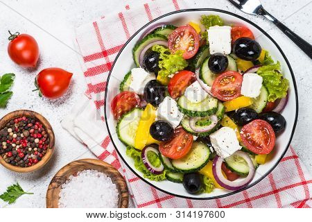Greek Salad. Vegetable Salad With Tomato, Cucumber, Salad Leaves, Feta Cheese And Olive Oil. Top Vie