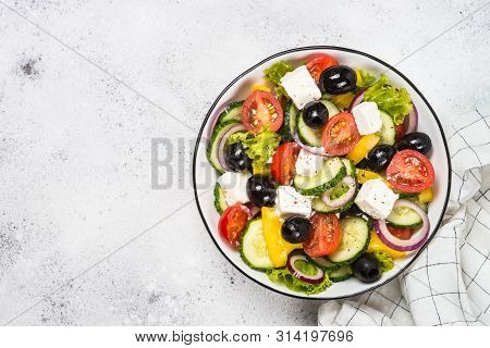 Greek Salad. Vegetable Salad With Tomato, Cucumber, Salad Leaves, Feta Cheese And Olive Oil. Top Vie