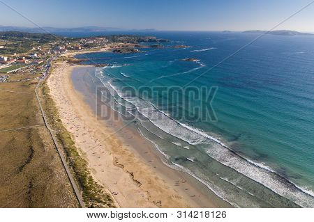 Ocean Waves, Sandy Beach With People Bathing In The Water, View From Drone, Lanzada Beach, Galicia,