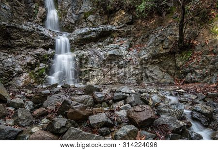 Beautiful Waterfall Of Mesa Potamos In Autumn With Yellow Maple Leaves On The Ground  At Troodos Mou