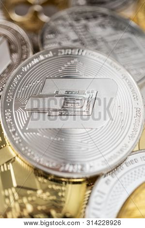 Dash Physical Coin On The Stack Of Other Different Cryptocurrencies. Close-up Photo Of Dash With Sha