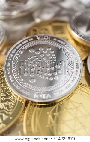 Iota Physical Coin On The Stack Of Other Different Cryptocurrencies. Close-up Photo Of Iota With Sha
