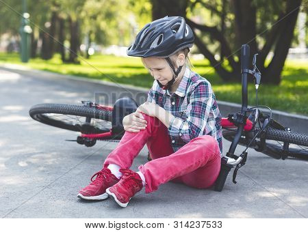 Girl Is Crying And Sitting Next To Her Bicycle, Fell Down From Bike, Got Hurt