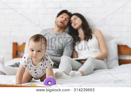 Dangerous Situation At Home. Baby Risk Of Fall Out Of Bed, Crawling To Side, Tired Parents Napping O