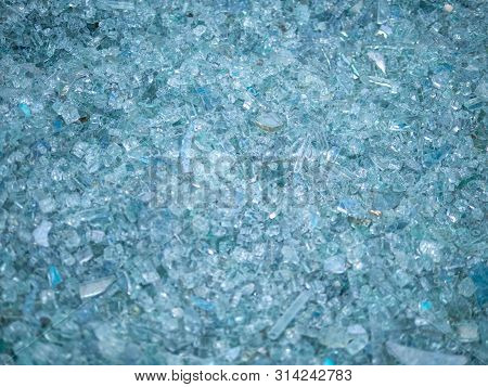 Background Of Clear Glass Broken Into Pieces. Close-up Broken Glass Pieces.