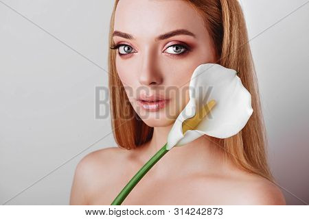 Portrait Of Happy Young Redhead Lady Looking Out Of White Flowers Studio Shot