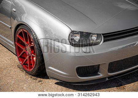 Moscow, Russia - July 19, 2019: Tuned Low Sport Hatchback With Red Candy Colored Alloy Wheels. Volks