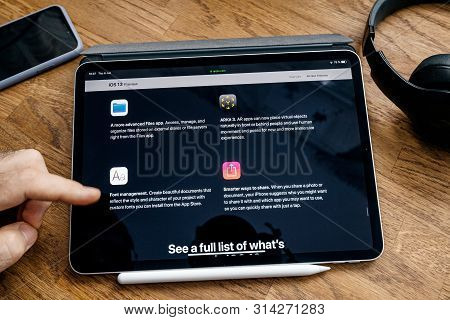 Paris, France - Jun 6, 2019: Man Reading On Apple Ipad Pro Tablet About Latest Announcement Of At Ap