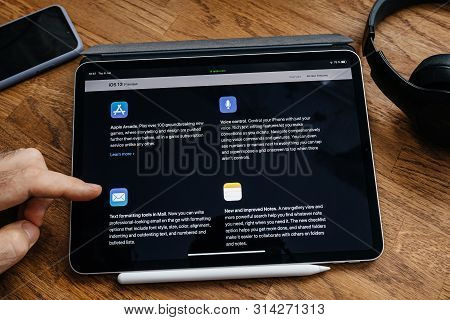 Paris, France - Jun 6, 2019: Man Reading On Apple Ipad Pro Tablet About Latest Announcement Of At Ap