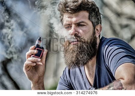 Man With Beard Breathe Out Smoke. Clouds Of Flavored Smoke. Bearded Man Smoking Vape. Smoking Electr