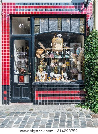 Gent, Flanders, Belgium -  June 21, 2019: Red And Black Facade With Display Window Of Louise And Mad