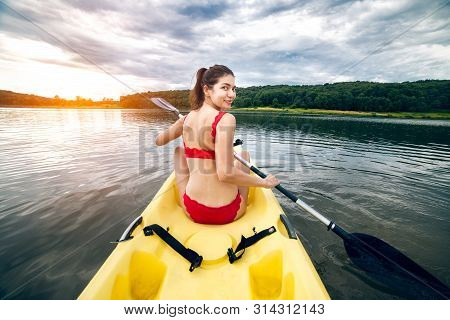 Happy Woman Enjoy Paddeling On Kayak Boat On A Forest Lake