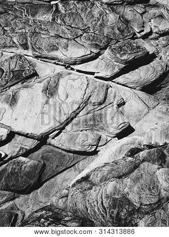 Background Texture Of The Stone Wall Of Rocks In Gray, Black White Colors.