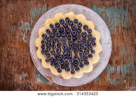 Homemade Cheesecake Decorated With Blueberry Over On Fabric. Top View