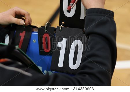 Young Boy Turns Number On Abacus In A Volleyball Match. Determining The Score. Tournament Recorder. 