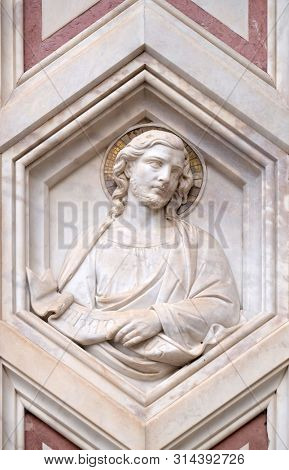 FLORENCE, ITALY - JANUARY 09, 2019: Saint Judas Thaddaeus, relief on the facade of Basilica of Santa Croce (Basilica of the Holy Cross) - famous Franciscan church in Florence, Italy