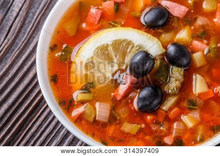 Traditional Russian Meat Soup Solyanka In Bowl On Rustic Wooden Table