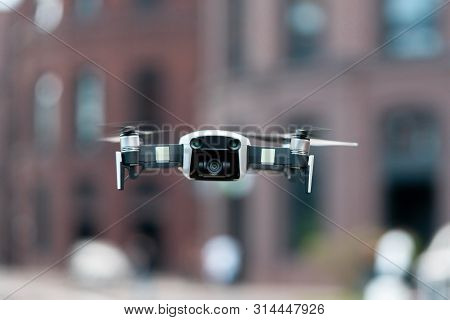Close Up Of Drone Quadcopter Inflight. Cityscape Background.