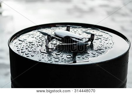 Close Up Of Drone Quadcopter On Black Wet Backround.