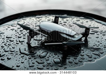 Close Up Of Drone Quadcopter On Black Wet Backround.