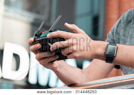 Close Up Of Man With Drone Quadcopter Joystick Controller At Urban Background.