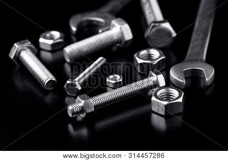 Wrenches And Bolts With Nuts On A Black Background.bolts And Nuts Close Up. Tools For Work. Bolts An