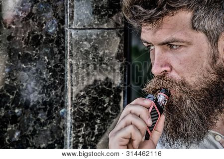 Bearded Man Smoking Vape. Man With Beard Breathe Out Smoke. Smoking Electronic Cigarette. Stress Rel