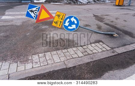 Traffic Sign That Has Been Driven Over So That The Metal Pole Is Bended On The Ground On A Spring Da