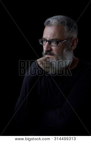 Artistic Portrait Of A Brutal Gray Haired Man With A Beard And Glasses On A Black Background, Select